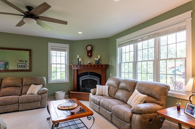 living room featuring plenty of natural light and ceiling fan