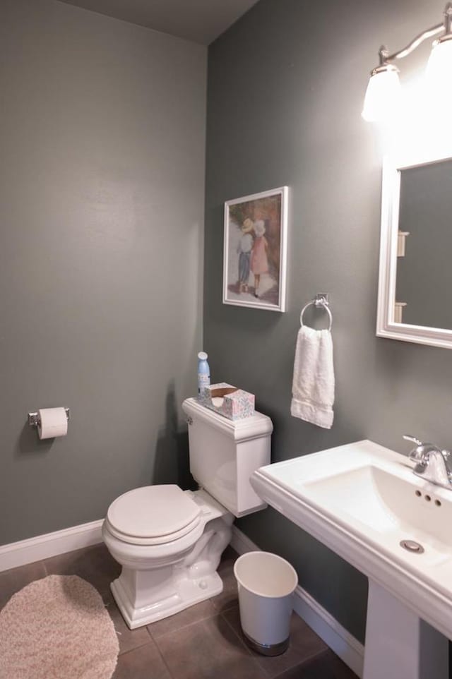 bathroom with tile patterned flooring, sink, and toilet