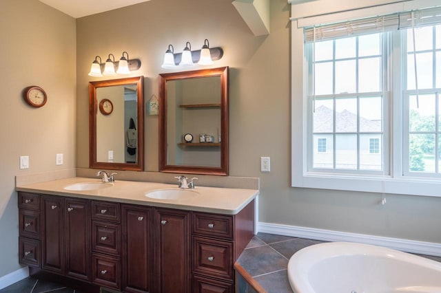 bathroom featuring vanity, a bath, and tile patterned floors