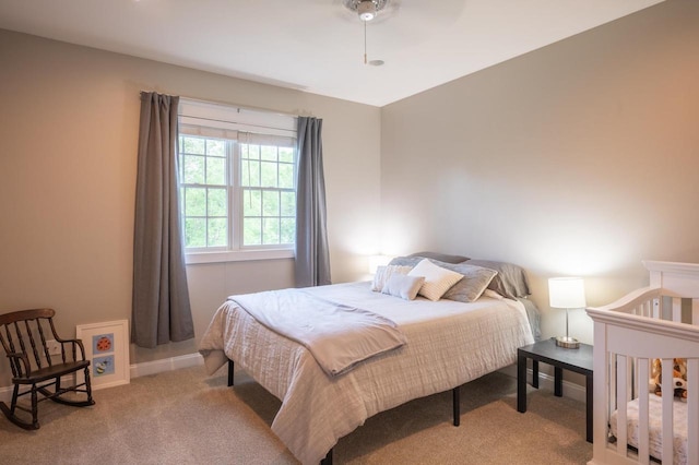 bedroom featuring light colored carpet and ceiling fan