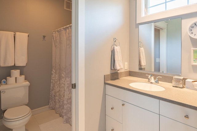 bathroom featuring vanity, toilet, and tile patterned flooring