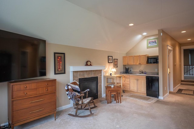 interior space with sink, vaulted ceiling, light carpet, and black appliances