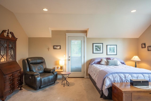 bedroom with vaulted ceiling and light carpet