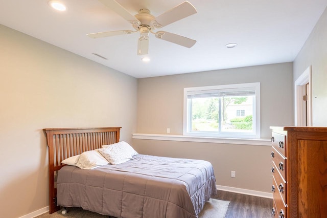 bedroom with dark hardwood / wood-style floors and ceiling fan