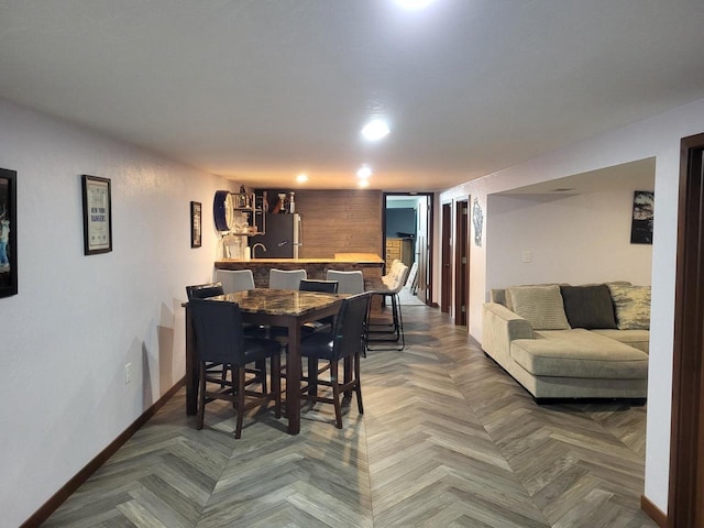 dining space with parquet flooring