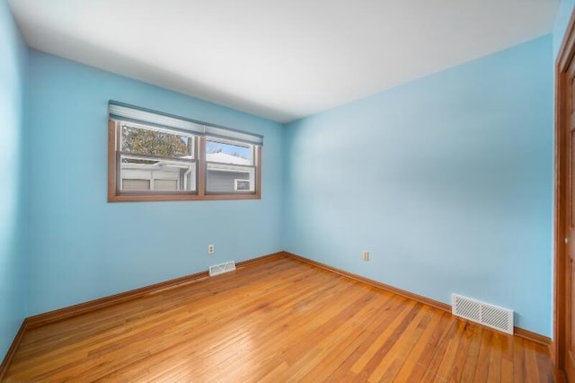 spare room with light hardwood / wood-style flooring