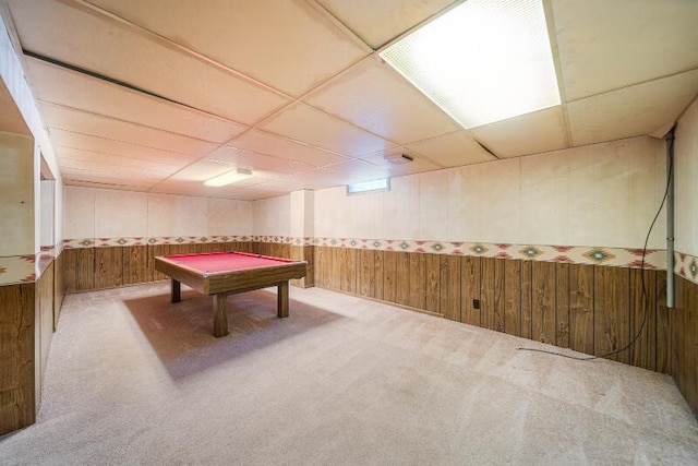 game room with a paneled ceiling, carpet flooring, pool table, and wood walls