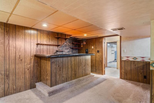 bar featuring wooden walls and carpet