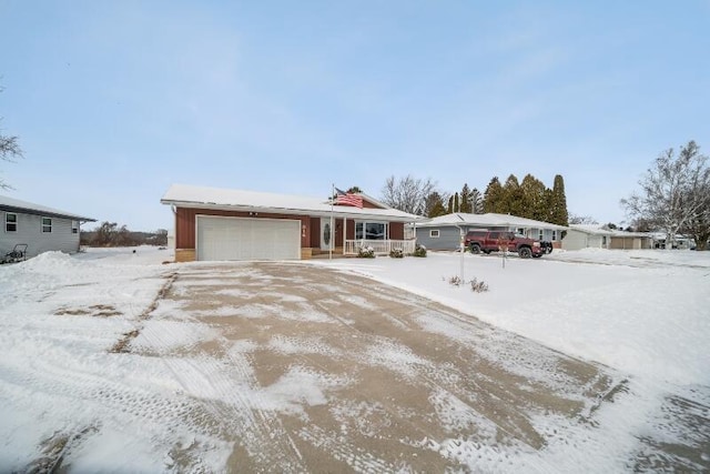 ranch-style home with a garage and covered porch