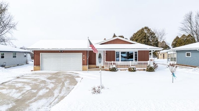 ranch-style house with a garage and covered porch