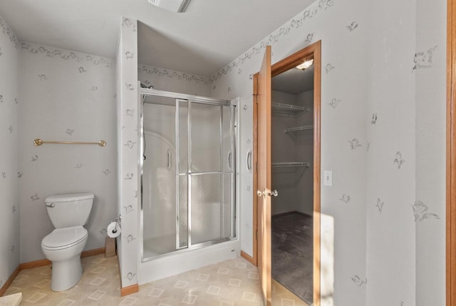 bathroom featuring an enclosed shower and toilet