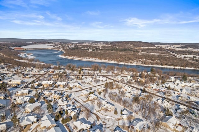 snowy aerial view with a water view