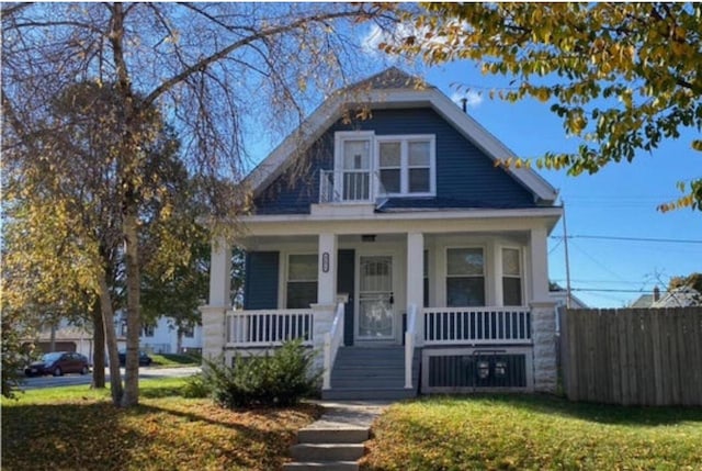 view of front of house featuring a front yard and covered porch