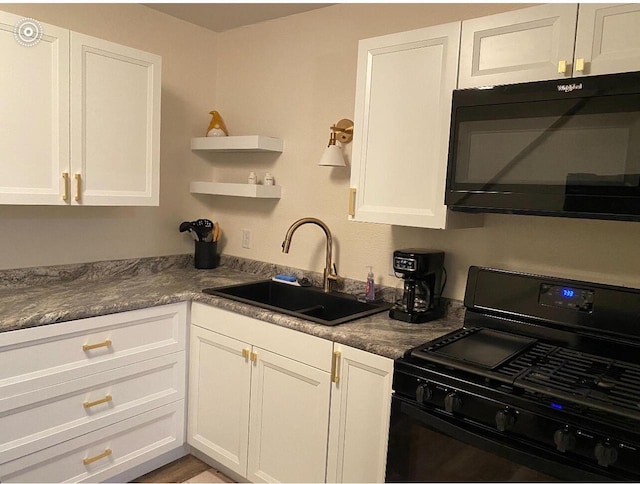 kitchen featuring sink, white cabinets, and black appliances