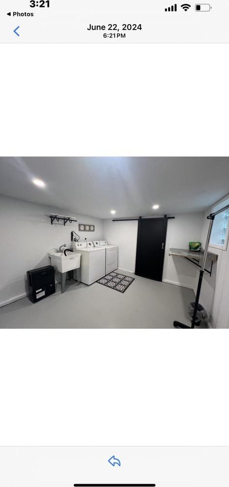 interior space featuring separate washer and dryer, sink, and concrete flooring