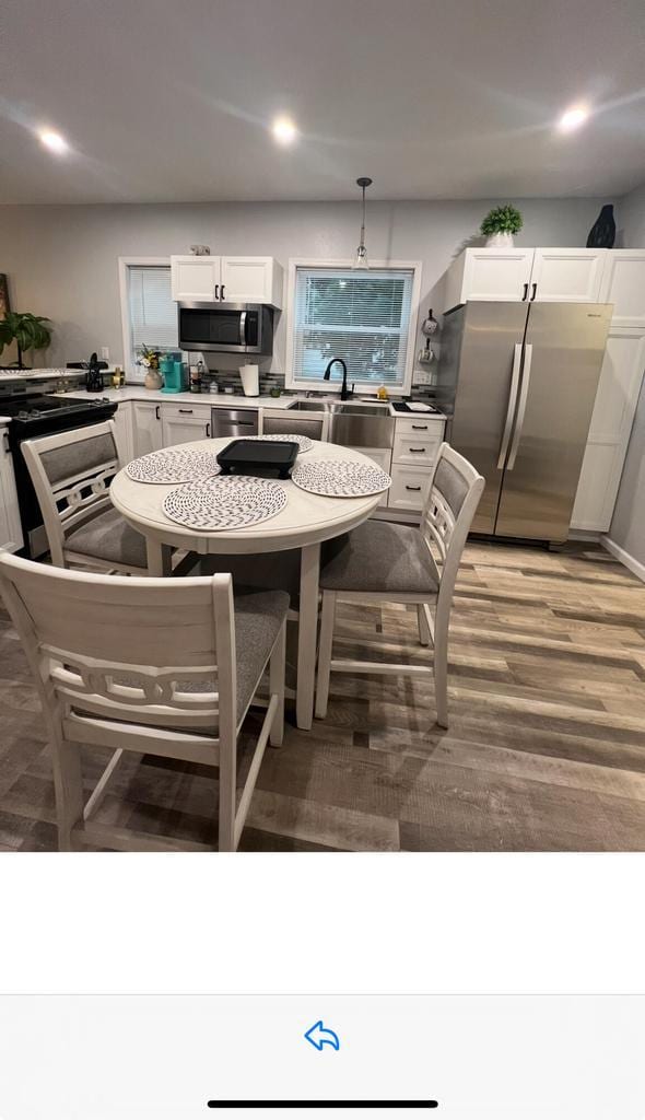 dining space featuring sink and light hardwood / wood-style flooring