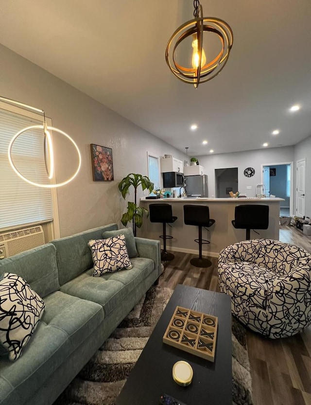 living room featuring cooling unit and dark hardwood / wood-style floors