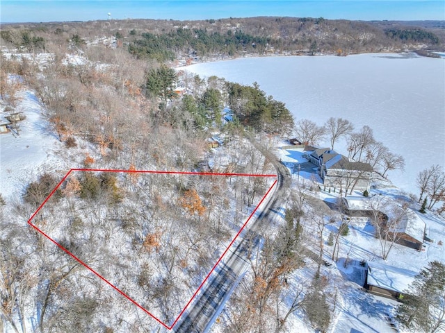 snowy aerial view featuring a water view