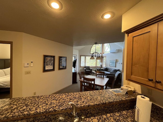 dining area featuring lofted ceiling, carpet floors, and a wall mounted air conditioner