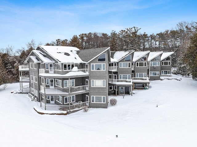 view of snow covered rear of property