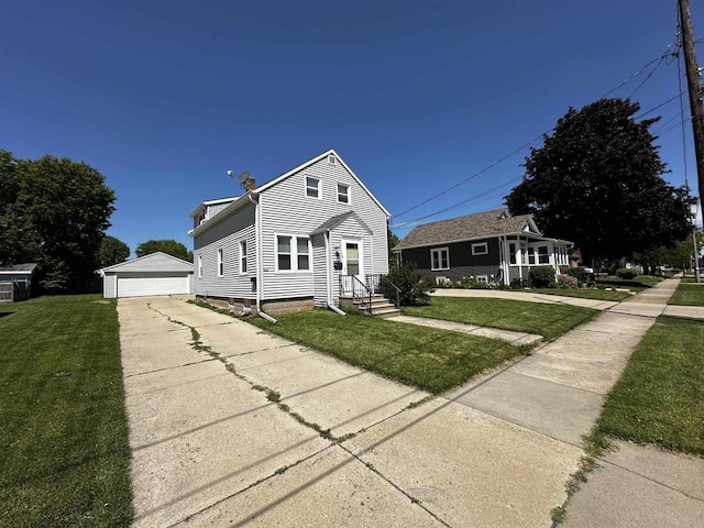 view of front facade featuring an outbuilding, a garage, and a front yard