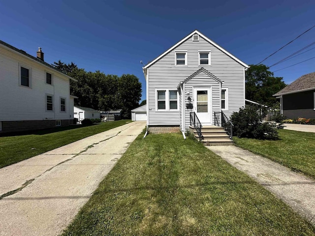 view of front of house featuring a garage, an outdoor structure, and a front yard