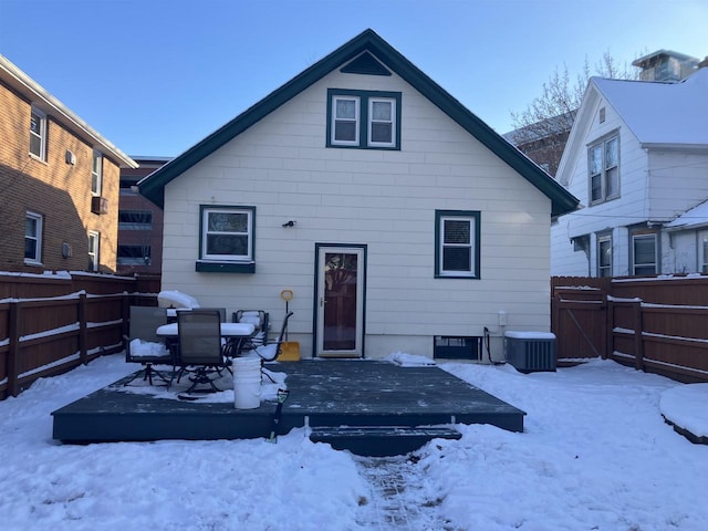 snow covered rear of property featuring cooling unit, a gate, fence, and a wooden deck