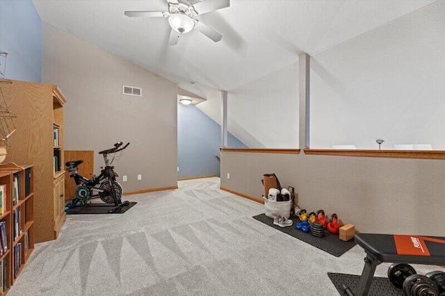 workout area with ceiling fan, lofted ceiling, and light carpet