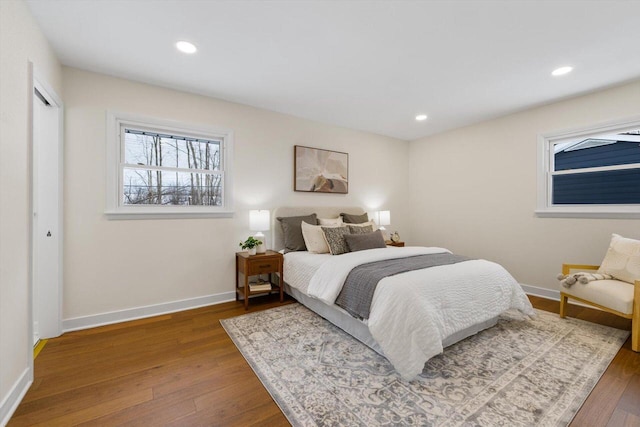 bedroom with dark hardwood / wood-style flooring