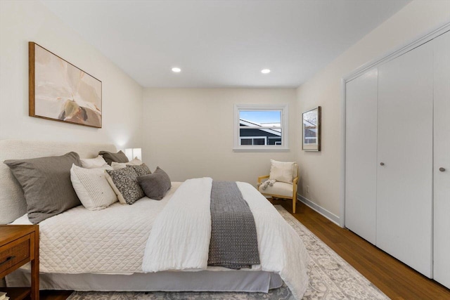 bedroom with wood-type flooring and a closet