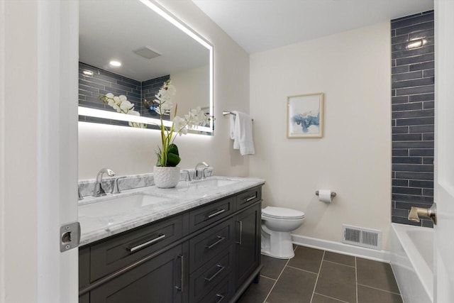 bathroom featuring vanity, tile patterned floors, and toilet