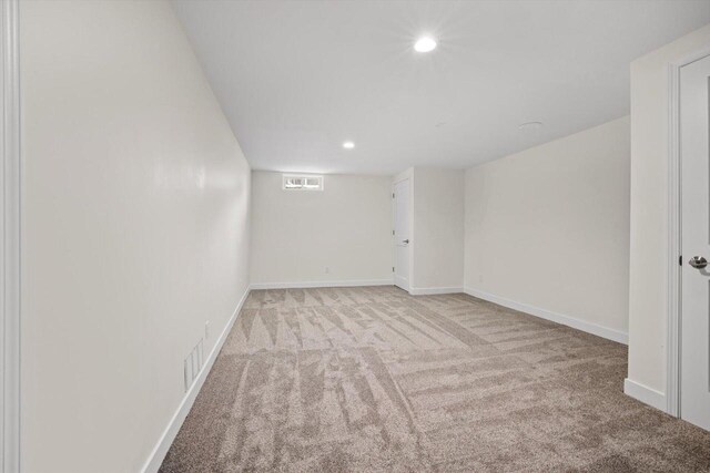 basement featuring light carpet