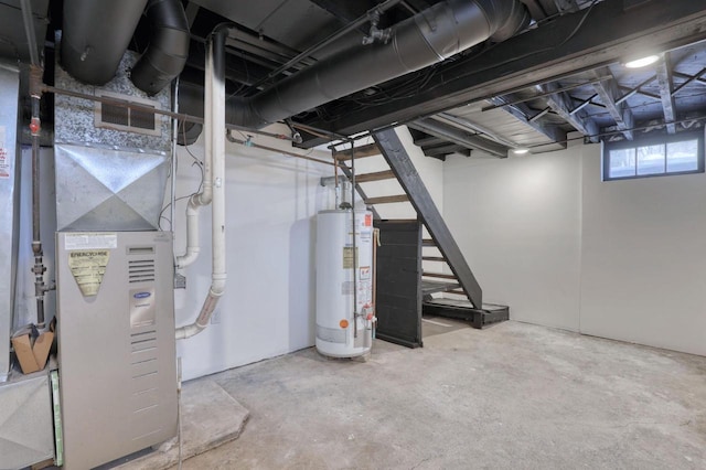 below grade area with gas water heater, visible vents, heating unit, and stairs