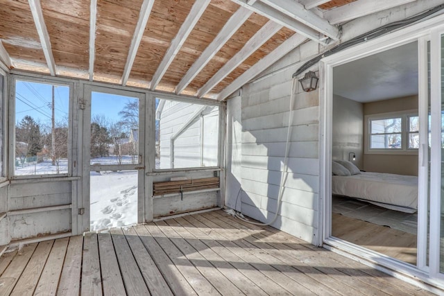 unfurnished sunroom featuring vaulted ceiling