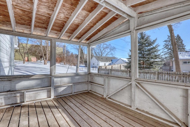 unfurnished sunroom featuring lofted ceiling