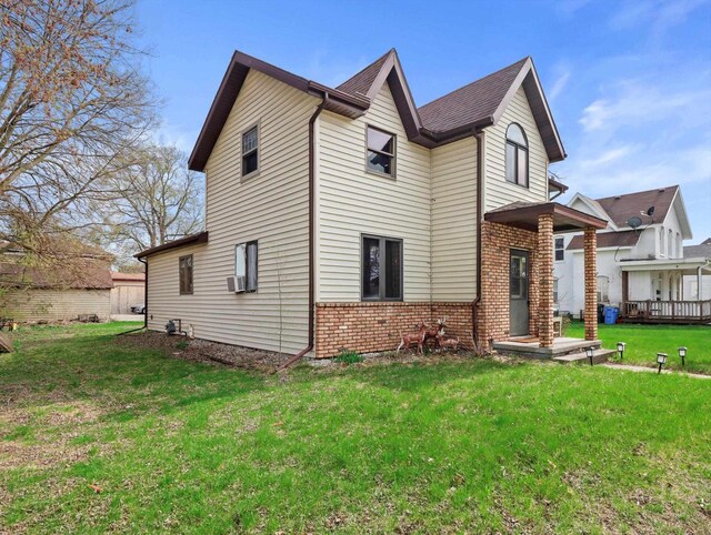 132 E Carroll St, Portage, WI 53901 - view of side of property with brick siding, a yard, and cooling unit