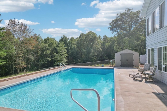 view of pool featuring a storage unit and a patio area