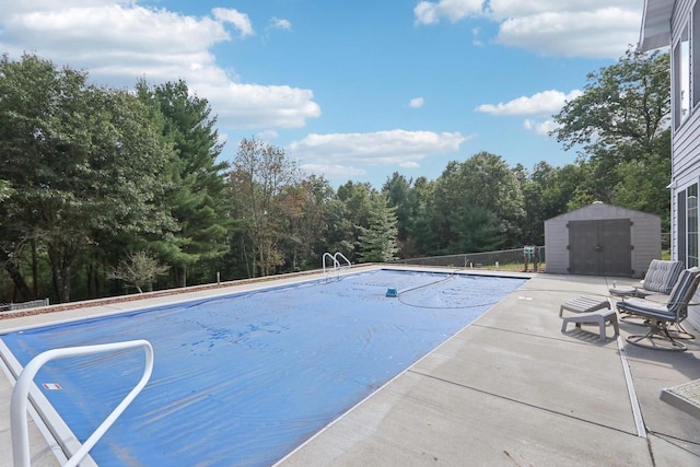 view of pool featuring a patio area and a storage shed