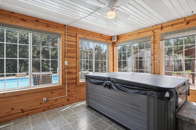 sunroom / solarium with a hot tub, a wealth of natural light, wooden ceiling, and ceiling fan