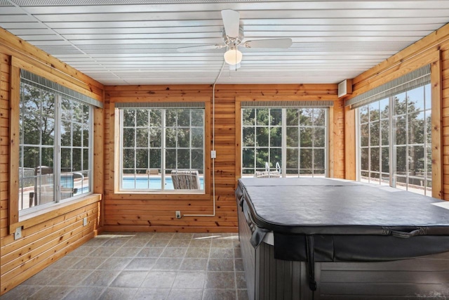 unfurnished sunroom featuring ceiling fan