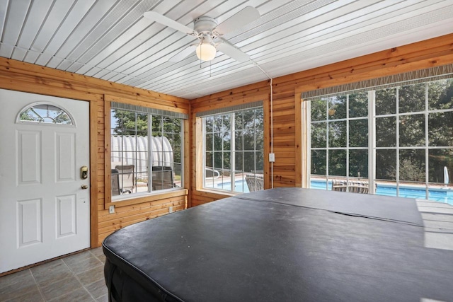 interior space with ceiling fan