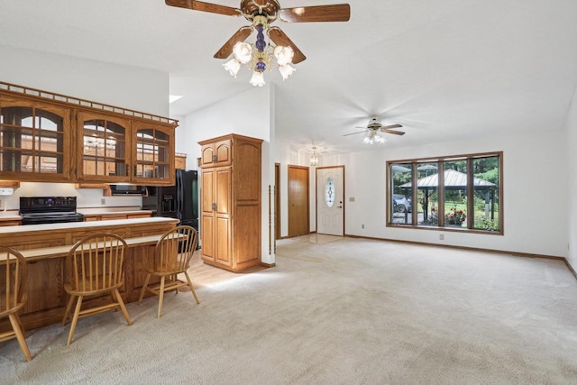 kitchen featuring vaulted ceiling, light carpet, ceiling fan, and black appliances