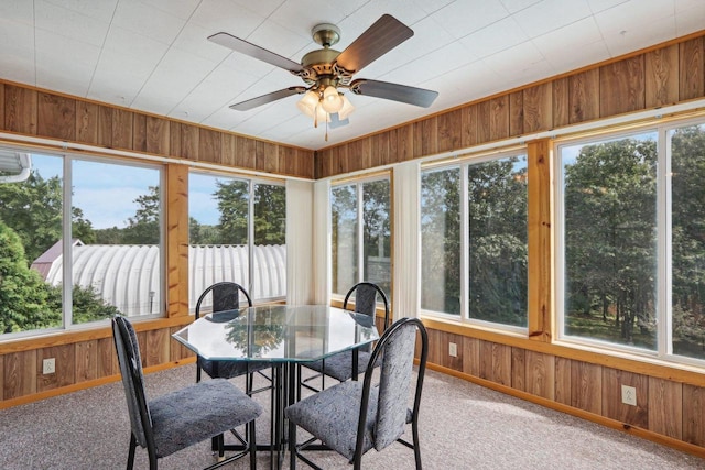 sunroom / solarium featuring ceiling fan