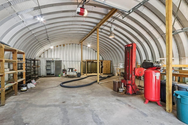 misc room featuring concrete flooring and lofted ceiling