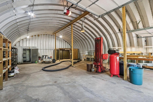 miscellaneous room with concrete flooring and vaulted ceiling