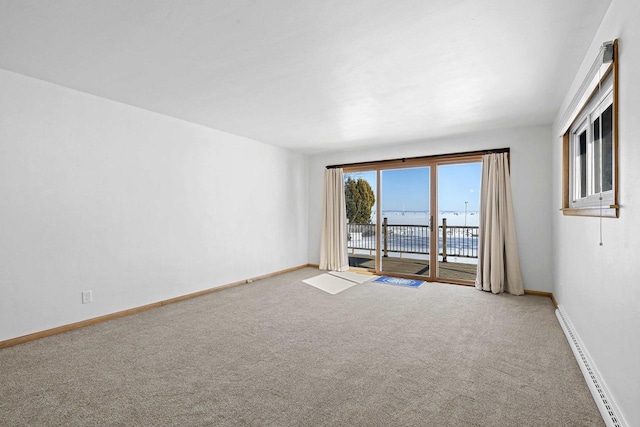 90 Lake St, Oshkosh, WI 54901 - carpeted spare room with a water view, baseboards, and a baseboard radiator