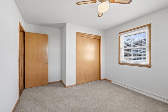90 Lake St, Oshkosh, WI 54901 - unfurnished bedroom with baseboards, baseboard heating, a closet, and light colored carpet