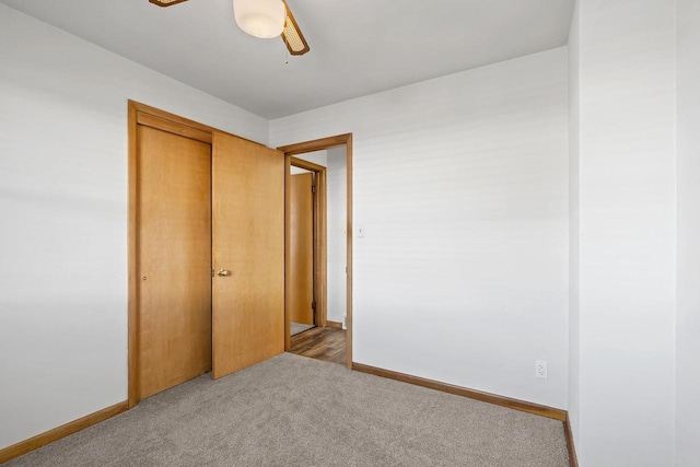 90 Lake St, Oshkosh, WI 54901 - unfurnished bedroom featuring a closet, a ceiling fan, carpet, and baseboards