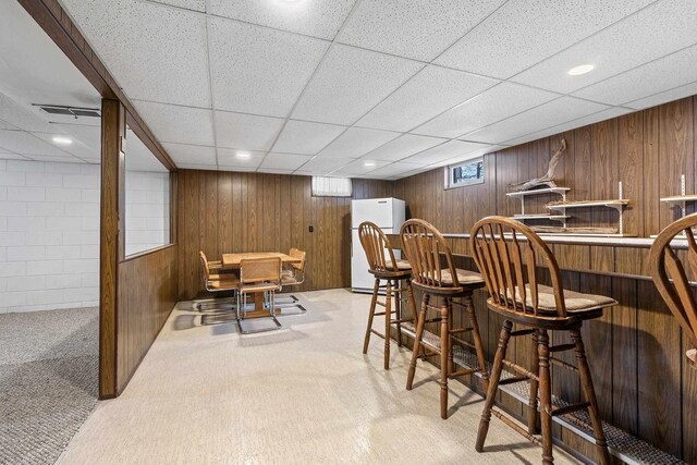 90 Lake St, Oshkosh, WI 54901 - bar featuring visible vents, freestanding refrigerator, a drop ceiling, carpet flooring, and bar area
