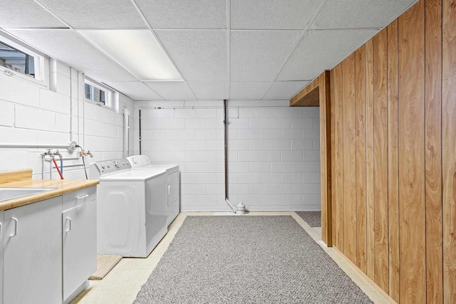 90 Lake St, Oshkosh, WI 54901 - washroom with wooden walls, concrete block wall, separate washer and dryer, and cabinet space